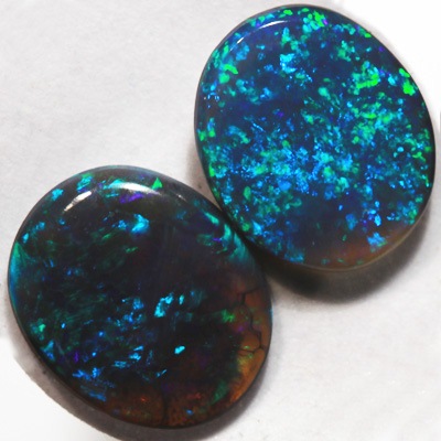 SOLID BLACK OPALS Matching pair. Bright green sparkles constantly